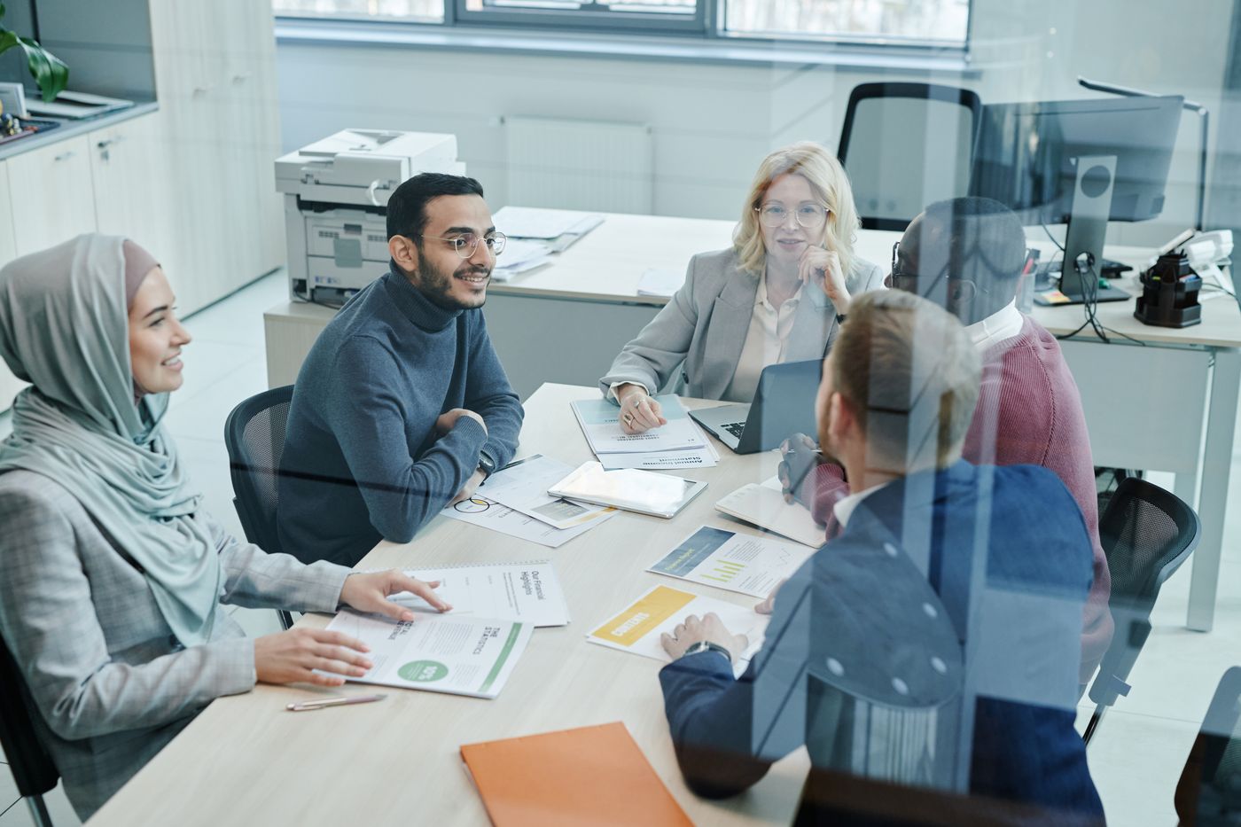 A team reviewing lead pipeline reports together in a bright open-plan office